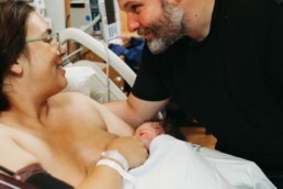 A beautiful mama and her loving husband and new son.