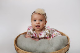 Baby posed in bucket for family photo