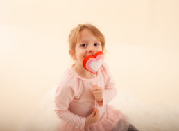 Toddler in studio photo shoot in Pasadena, California with valentine day themed props, heart