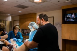 Photo of dad crying shortly after the birth of his newborn baby in the hospital birth